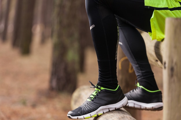 Close-up of trail running shoes on a dirt path