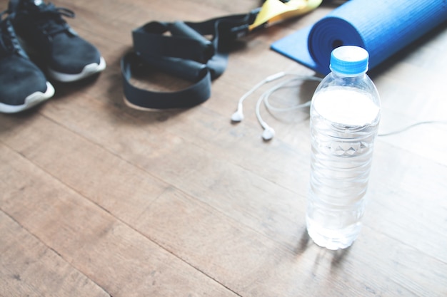 Glass water bottle on a desk with a calendar and notes