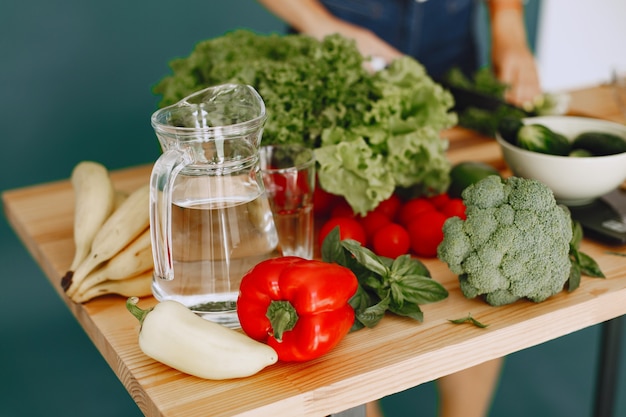Fresh cucumbers, celery, and bell peppers on a cutting board