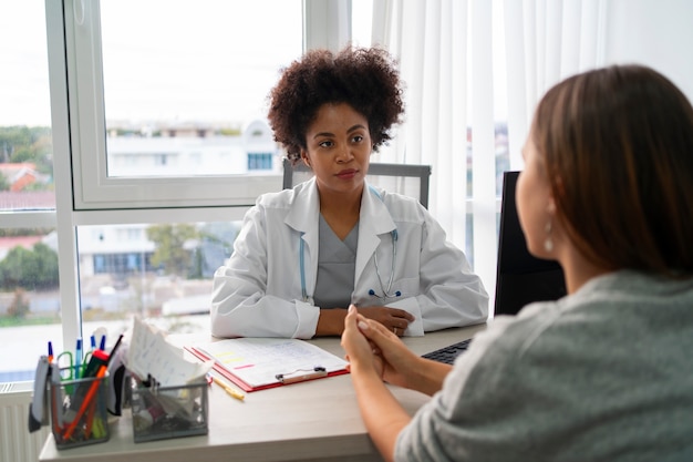 Woman speaking with a healthcare provider in a clinic