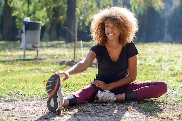 Woman jogging in park with fitness tracker