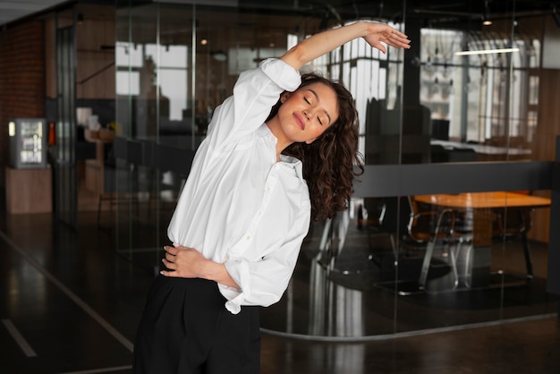 Woman stretching at her desk