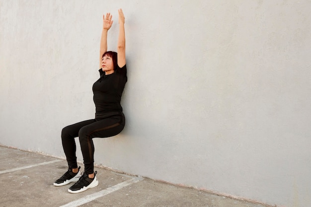 Postpartum woman doing legs-up-the-wall pose