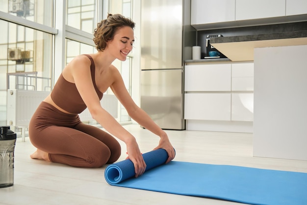 Person practicing yoga on a mat at home